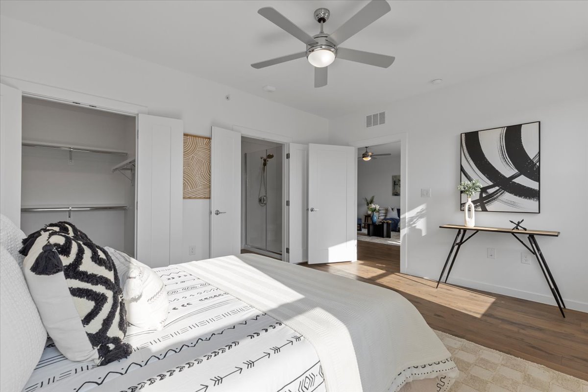 4801 Springdale Road, Unit 1107 Austin, TX 78723 - Photo 14 of 40 a bedroom with a bed and a chandelier