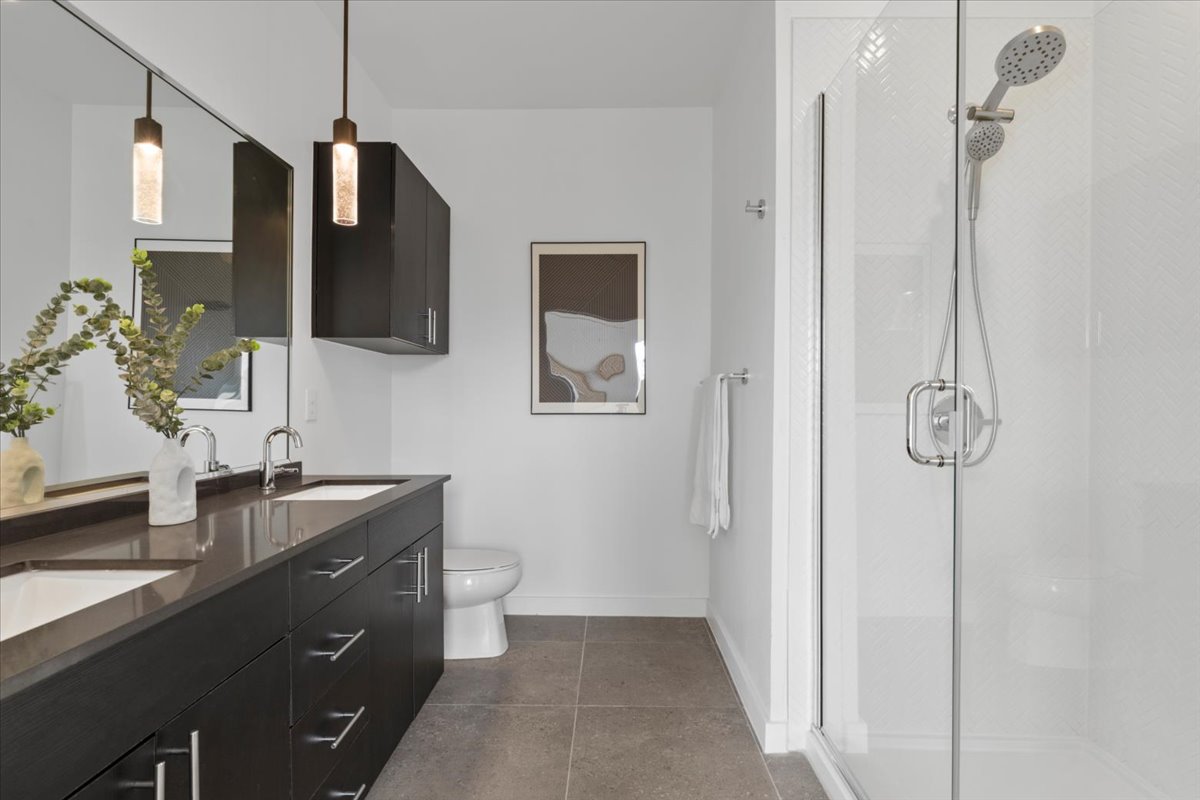 4801 Springdale Road, Unit 1107 Austin, TX 78723 - Photo 16 of 40 a spacious bathroom with a granite countertop sink a mirror and shower