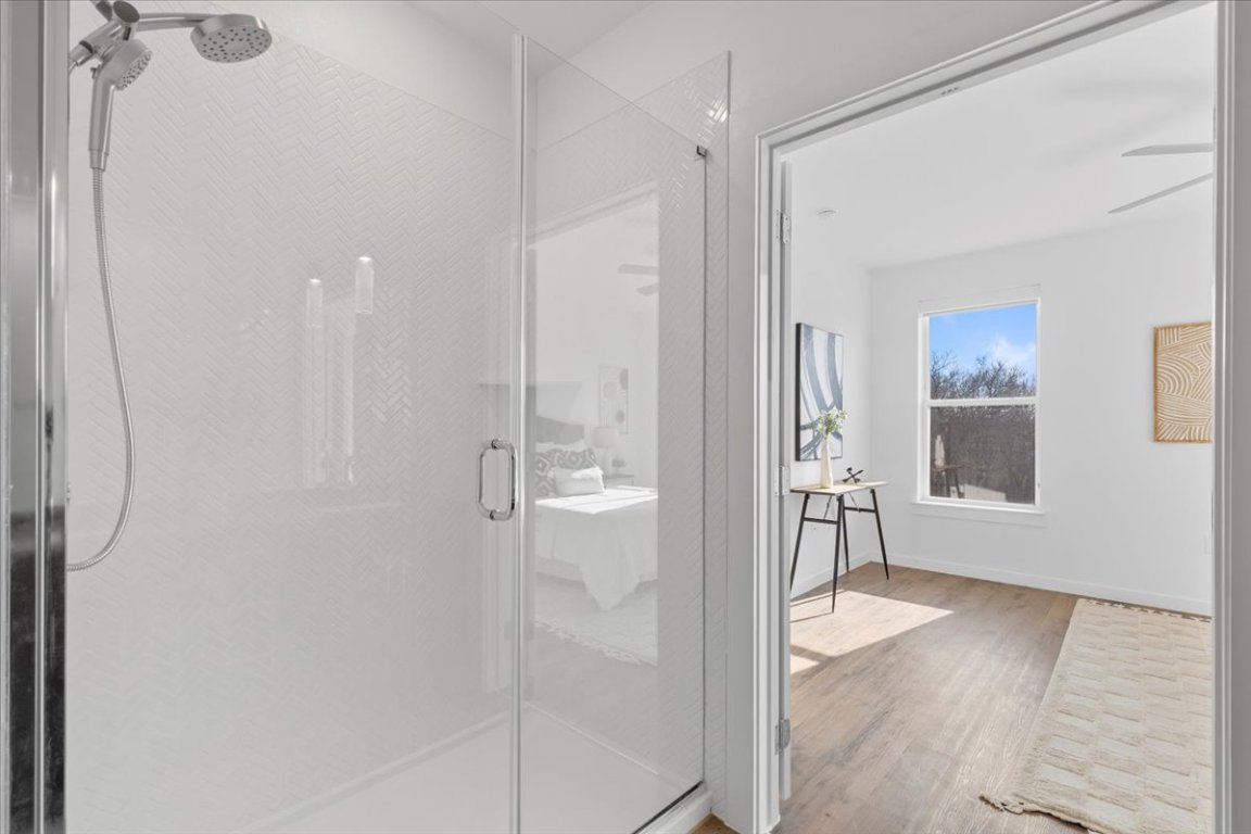 4801 Springdale Road, Unit 1107 Austin, TX 78723 - Photo 17 of 40 Bathroom featuring a shower stall and wood finished floors