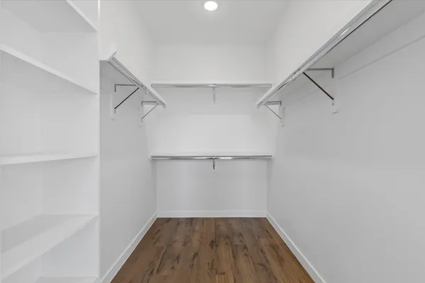a spacious bathroom with a granite countertop sink a mirror and shower