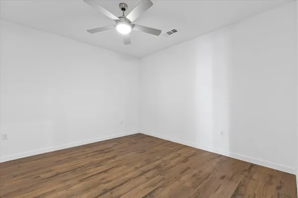 a view of a room with wooden floor