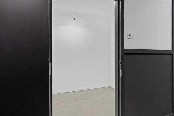 a view of a hallway with washer and dryer