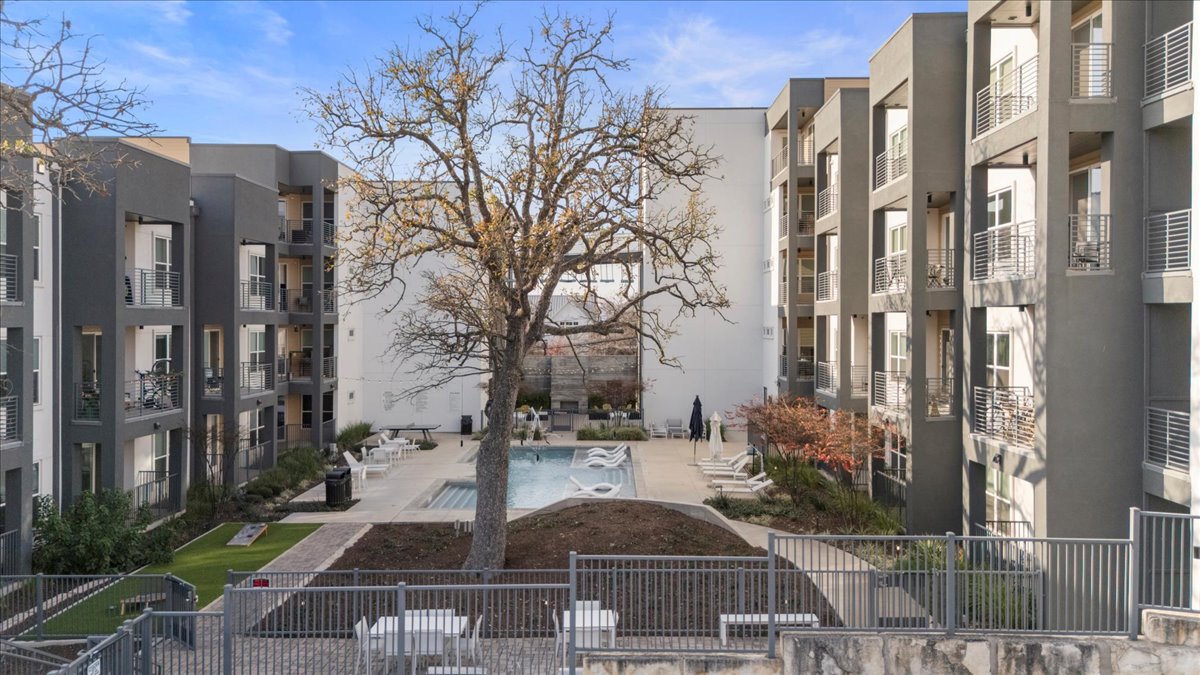 4801 Springdale Road, Unit 1107 Austin, TX 78723 - Photo 28 of 40 Surrounding community with a swimming pool and a patio area