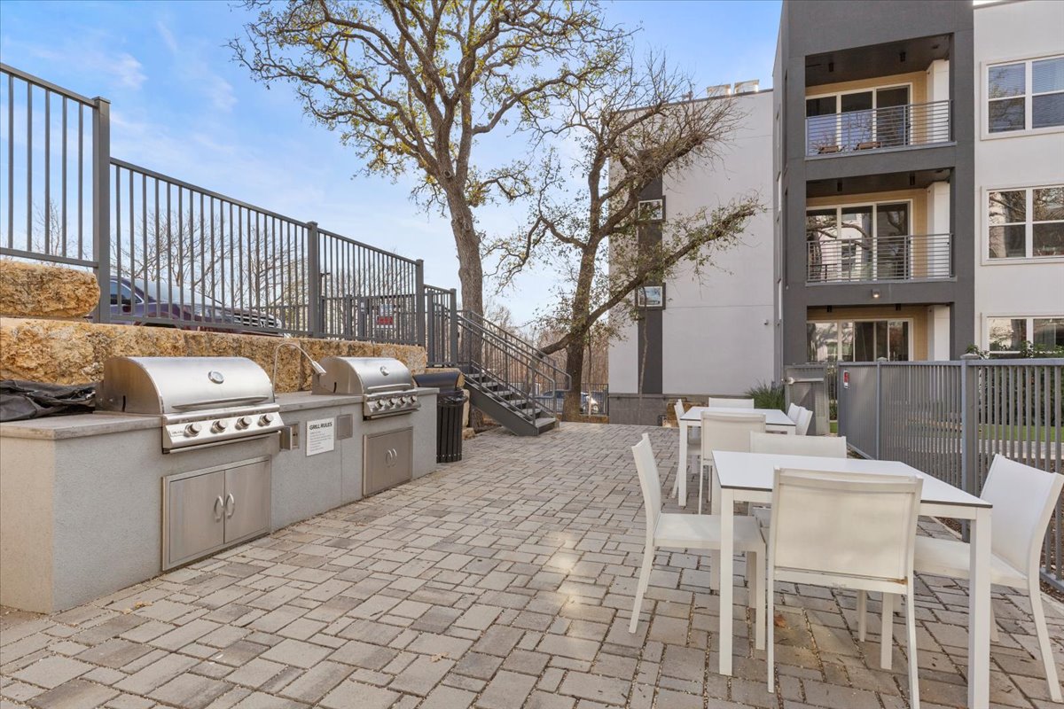 4801 Springdale Road, Unit 1107 Austin, TX 78723 - Photo 32 of 40 a dinning table and chairs in a patio