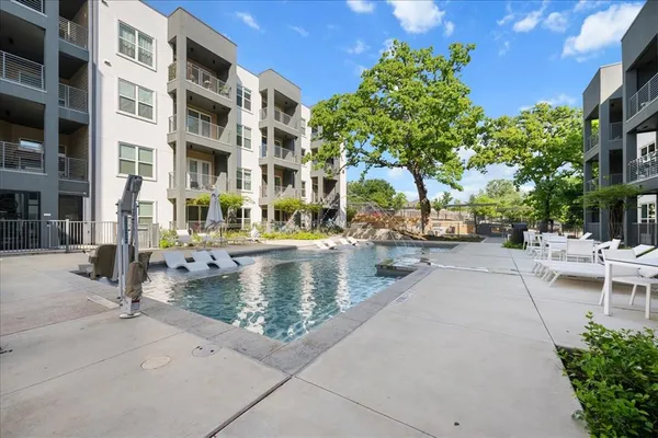 a view of yard with swimming pool and sitting area