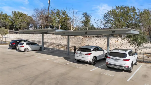 a view of a cars park in front of a house