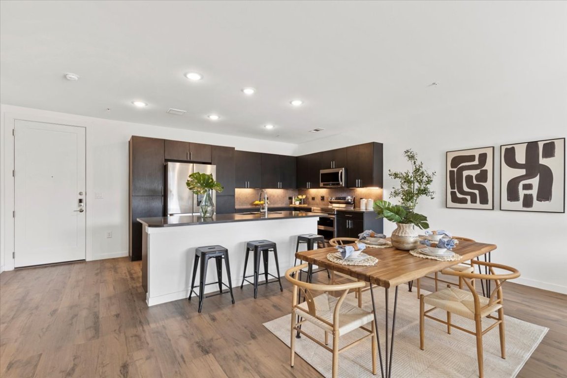 4801 Springdale Road, Unit 1107 Austin, TX 78723 - Photo 5 of 40 Dining room with light wood finished floors and recessed lighting