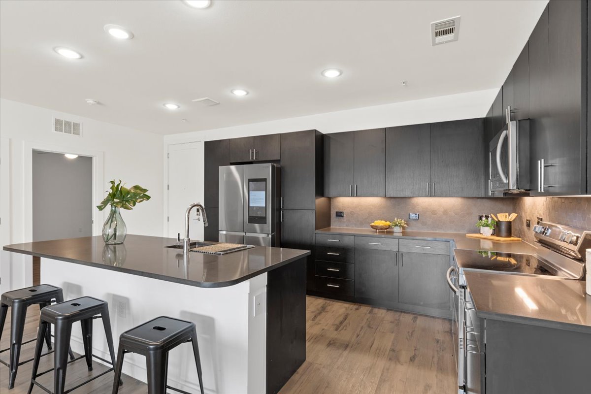 4801 Springdale Road, Unit 1107 Austin, TX 78723 - Photo 6 of 40 a kitchen with sink refrigerator and stove
