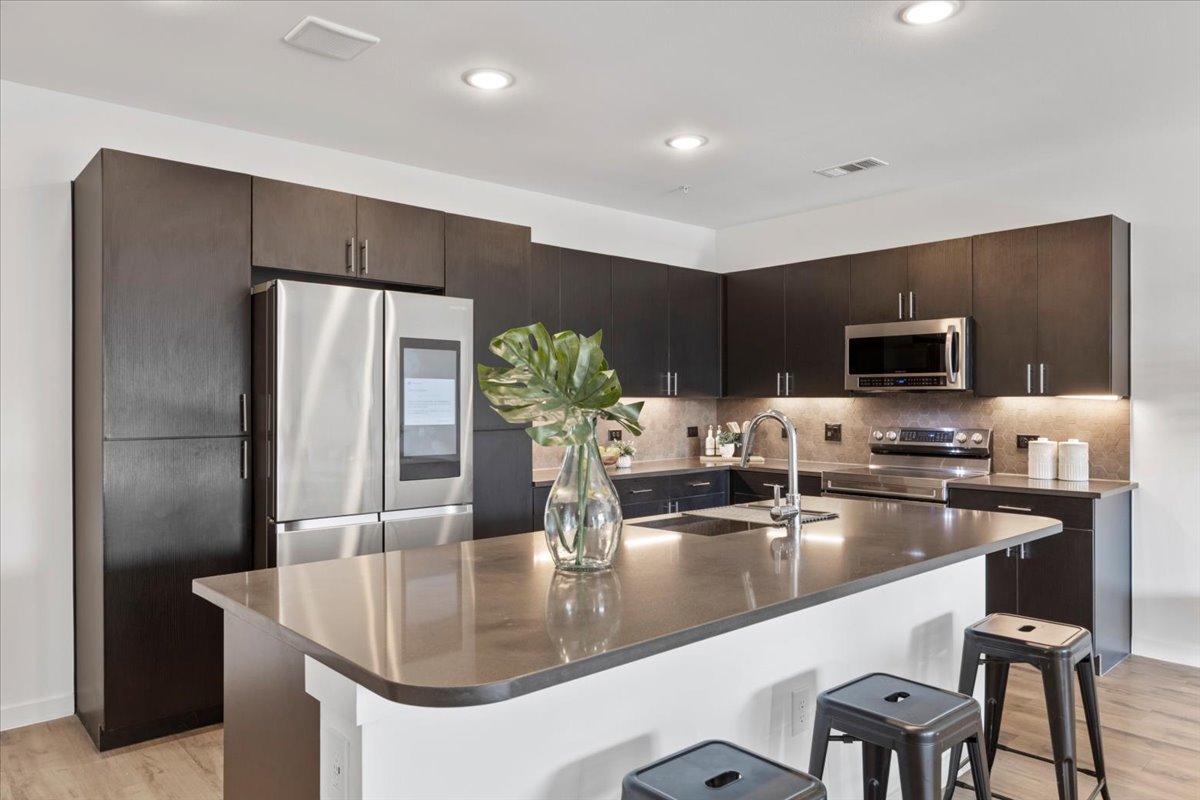 4801 Springdale Road, Unit 1107 Austin, TX 78723 - Photo 7 of 40 a kitchen with stainless steel appliances granite countertop a sink and a refrigerator