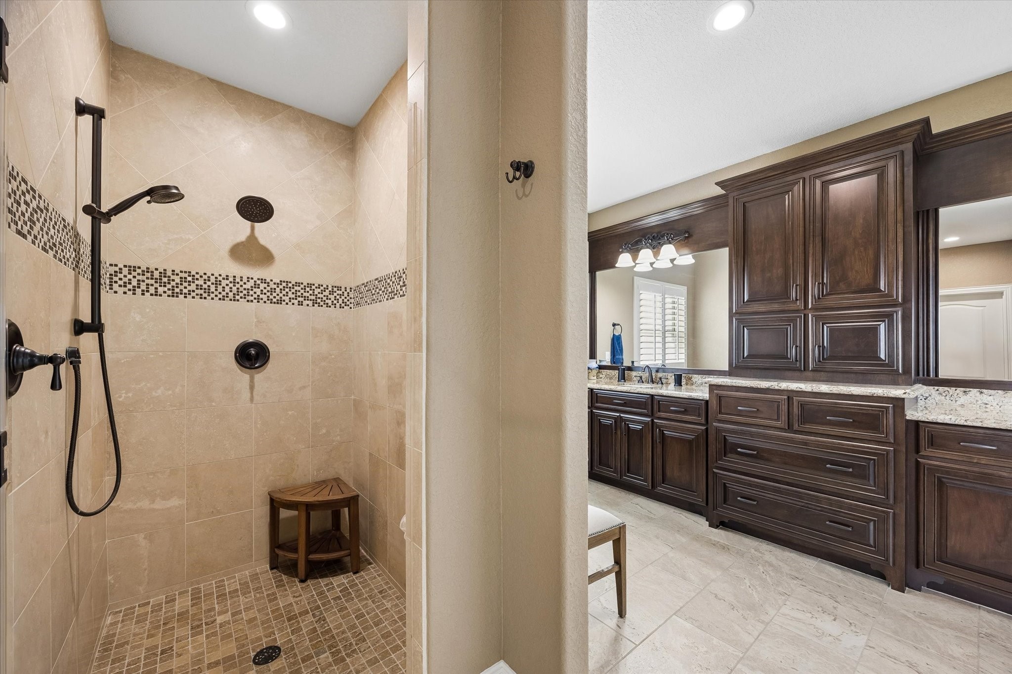 17703 Cedarhill Drive Rosharon, TX 77583 - Photo 18 of 47 a bathroom with a granite countertop sink a mirror a vanity and shower