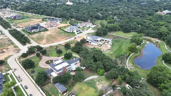an aerial view of a house a yard and mountain