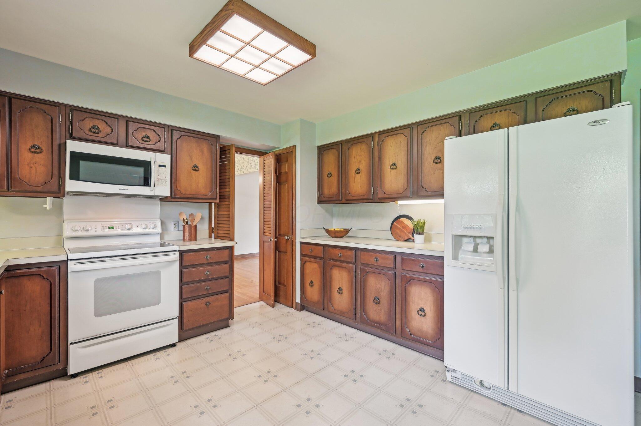 5917 Rocky Rill Road Columbus, OH 43235 - Photo 12 of 47 Kitchen – Additional Storage
Abundant cabinet storage and counter workspace, including a side-by-side refrigerator and built-in microwave.