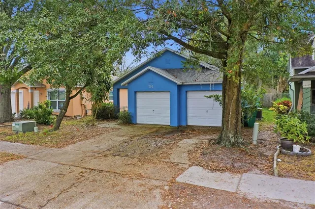 an aerial view of residential houses with outdoor space and river
