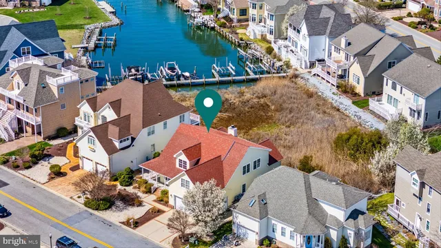 an aerial view of residential houses with outdoor space and swimming pool