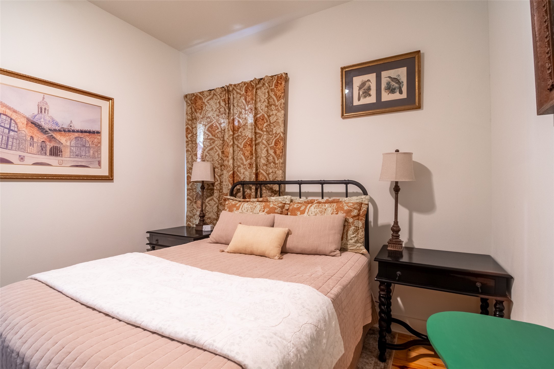 200 Carl Street Houston, TX 77009 - Photo 25 of 32 a bedroom with a bed and a lamp on dresser