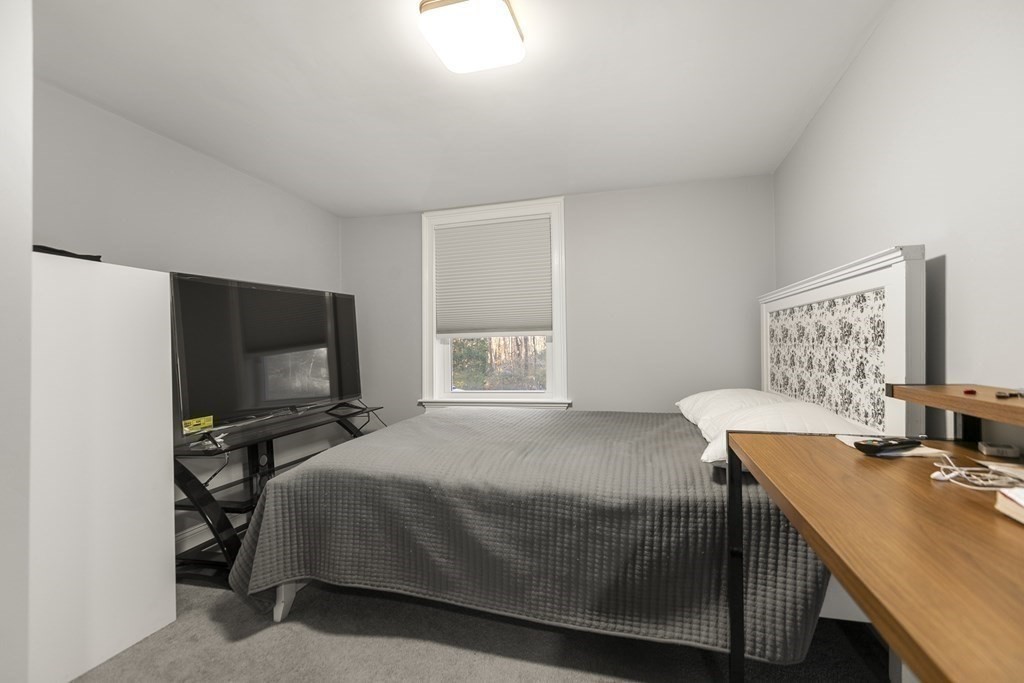 61 Patten Drive Marlborough, MA 01752 - Photo 14 of 20 a bedroom with a bed and a flat screen tv