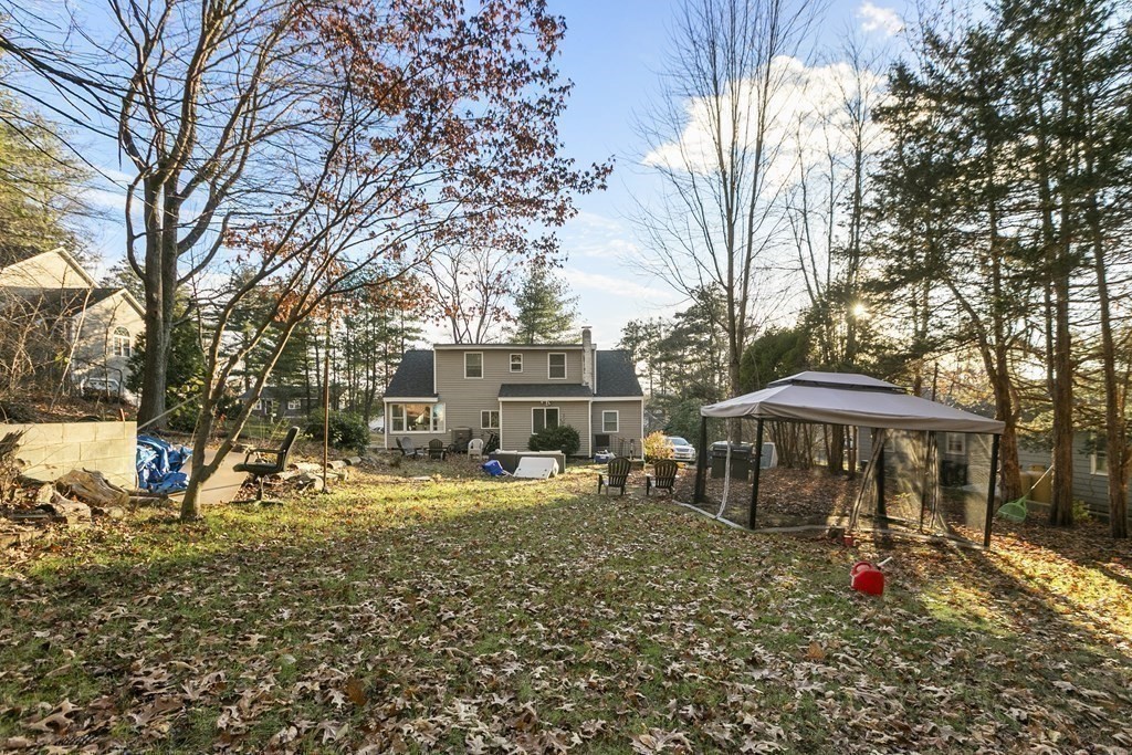 61 Patten Drive Marlborough, MA 01752 - Photo 19 of 20 a view of a house with a yard covered with snow and trees