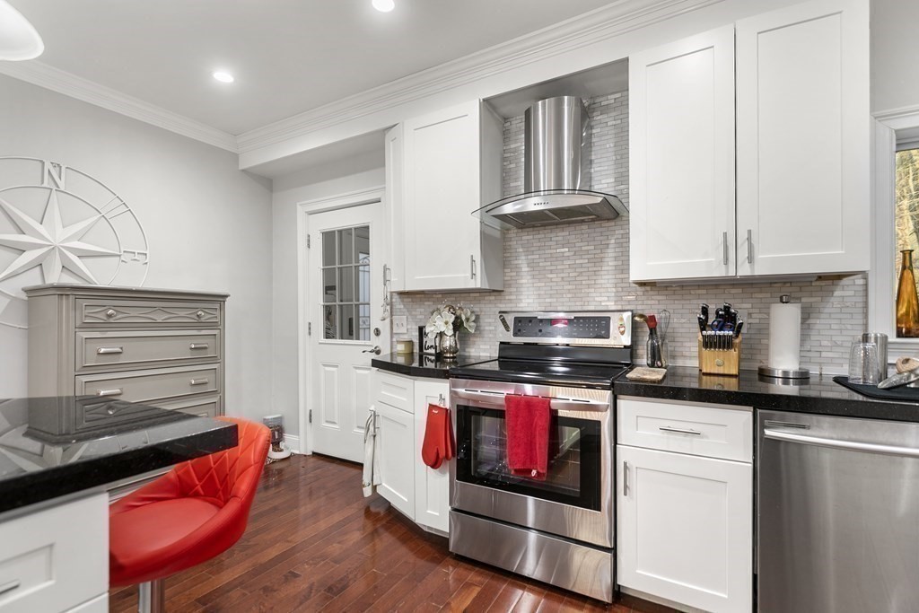 61 Patten Drive Marlborough, MA 01752 - Photo 3 of 20 a kitchen with stainless steel appliances granite countertop a stove and white cabinets