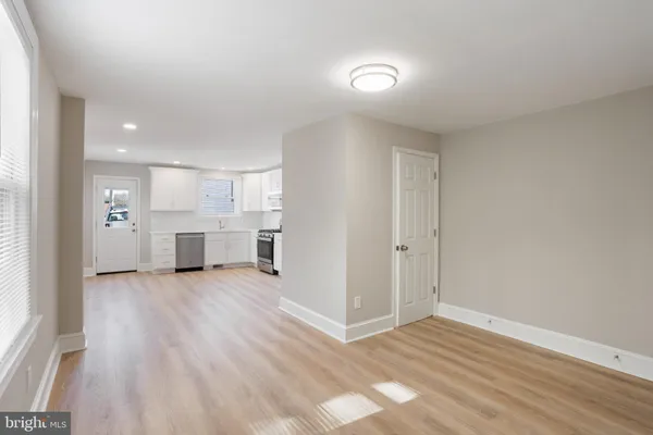a view of a kitchen with a sink and dishwasher kitchen view with wooden floor