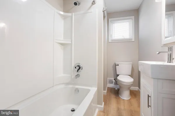 a bathroom with a toilet and a bathtub