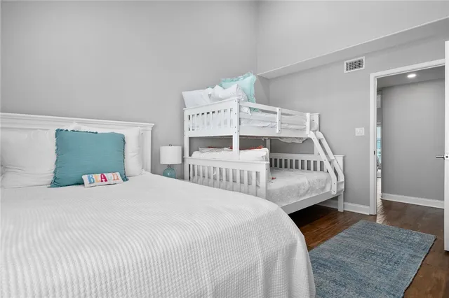 a white bed sitting in a bedroom next to a window