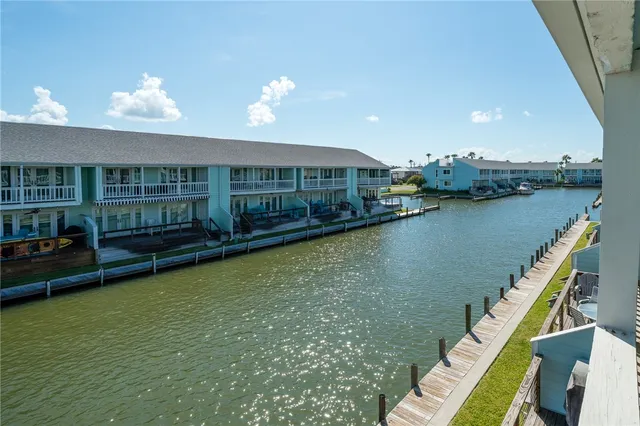 a view of a house with swimming pool and a yard