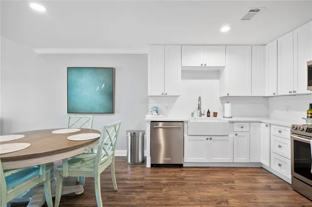 a kitchen with a stove a sink and a refrigerator