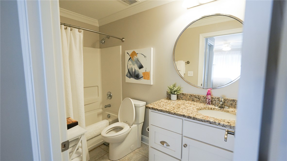 303 Lookover Drive Anderson, SC 29621 - Photo 30 of 46 This bright bathroom features a vanity with granite counters and a clean tub and shower combination.