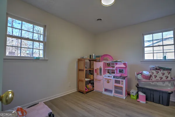 a room with toys and a wooden floor