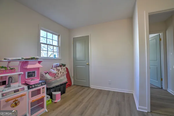 an bedroom with a bed and wooden floor