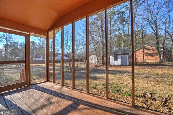 a view of a living room and floor to ceiling window