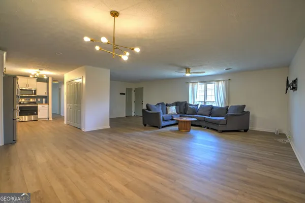 a living room with furniture and kitchen view
