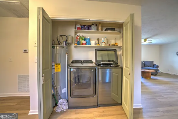a view of a living room with bathroom