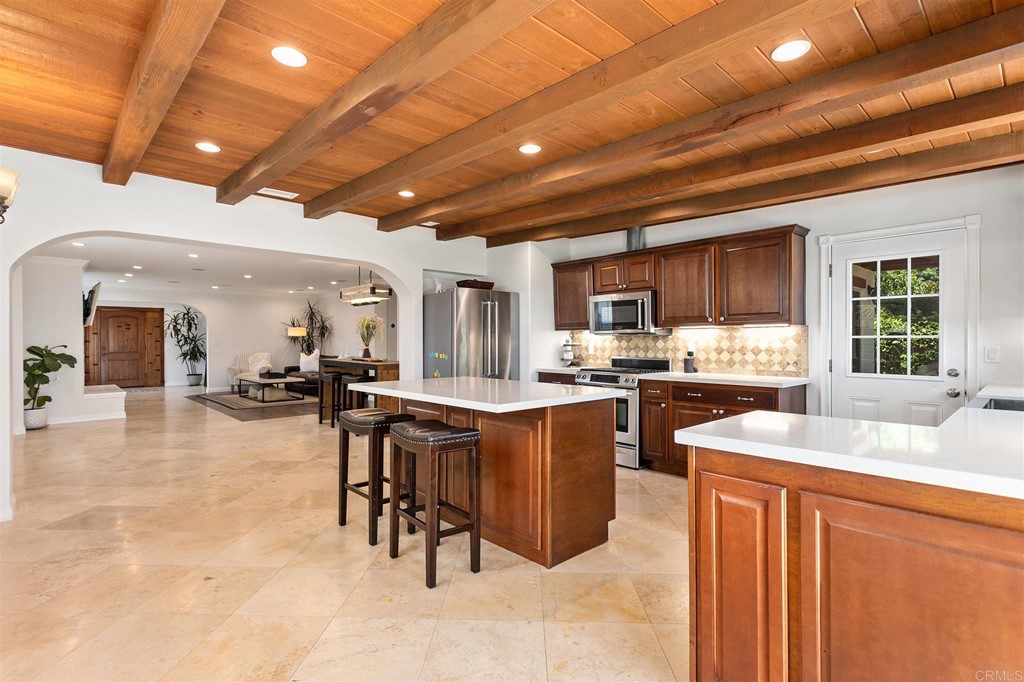 a kitchen with sink cabinets and dining table