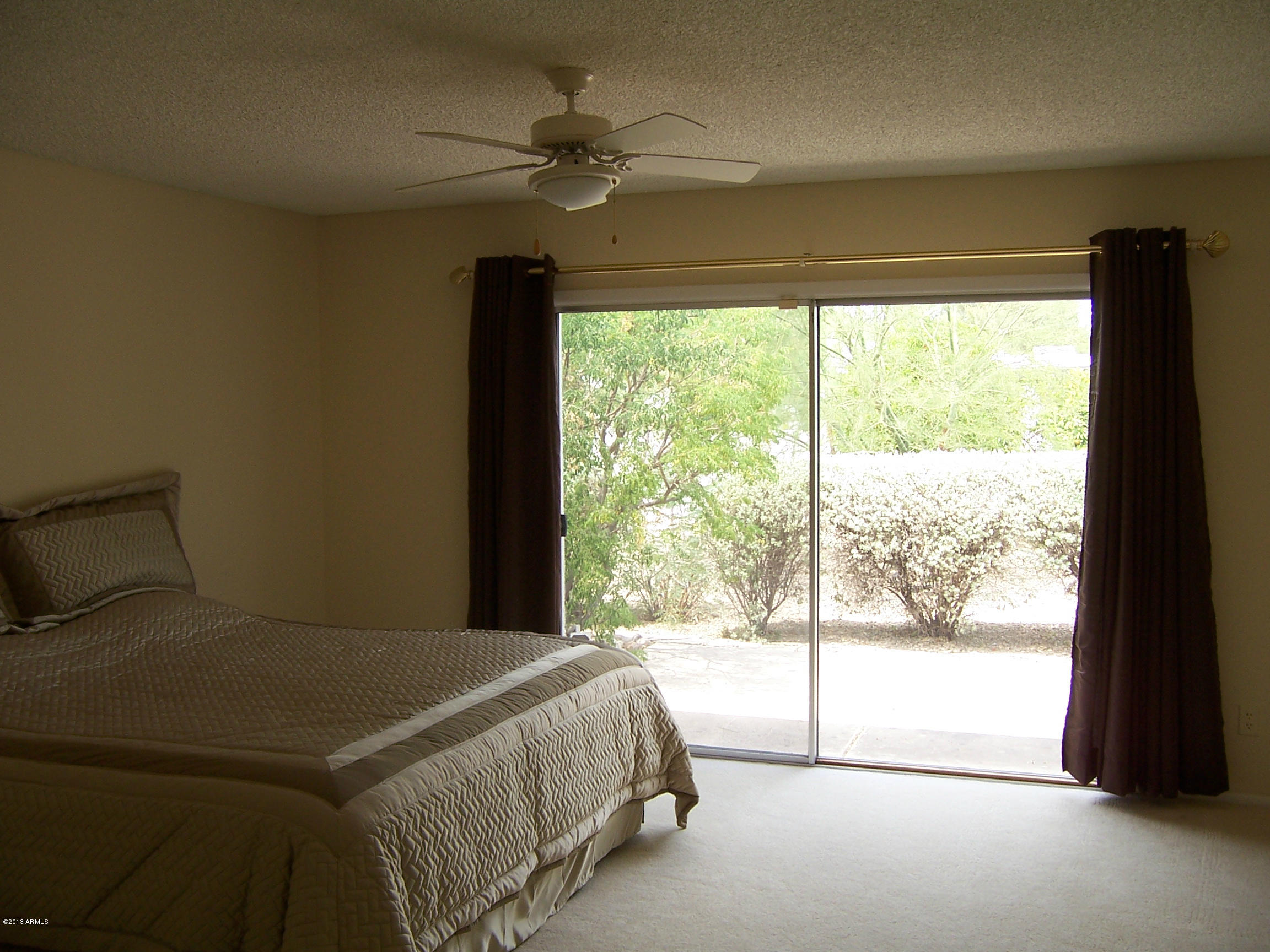 548 East Calavar Road Phoenix, AZ 85022 - Photo 21 of 32 a bedroom with a large bed and a large window
