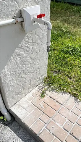 a front view of a house with a yard and potted plants