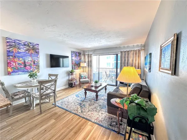 a living room filled with furniture and a wooden floor