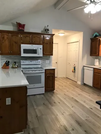 a kitchen with stainless steel appliances a stove sink and microwave