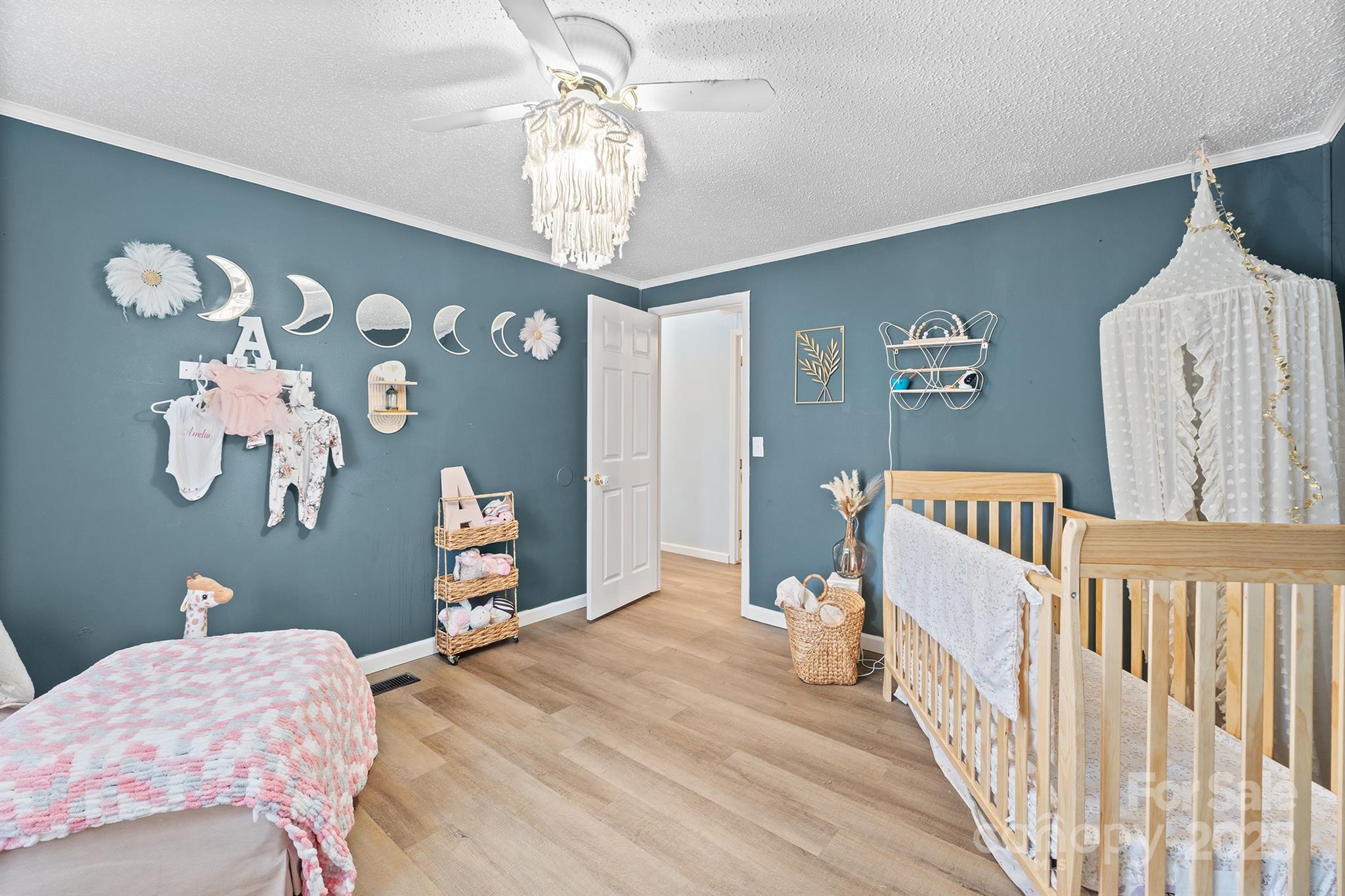 10483 Troutman Road Midland, NC 28107 - Photo 16 of 21 a bedroom with a bed and chandelier