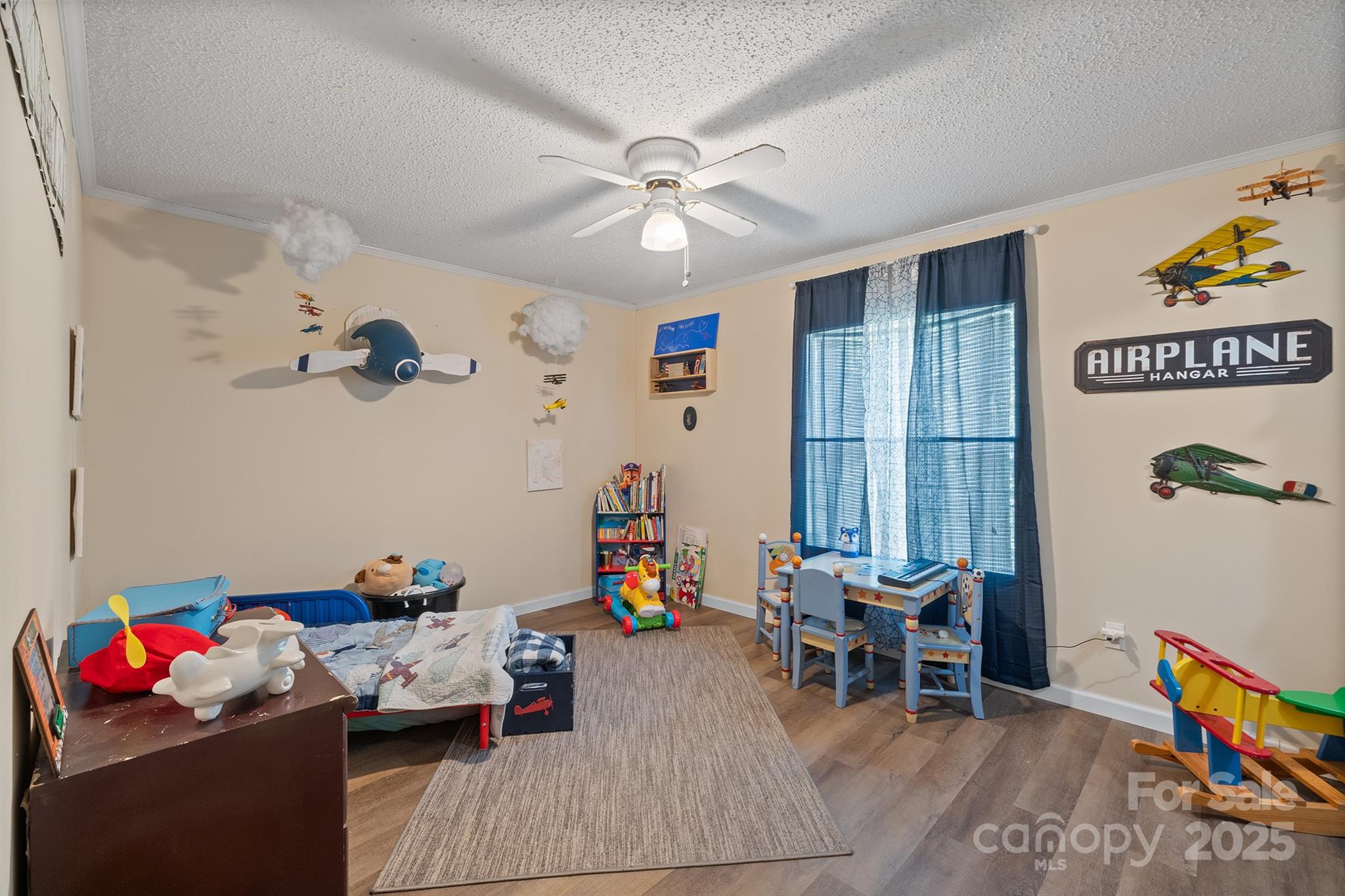 10483 Troutman Road Midland, NC 28107 - Photo 18 of 21 a living room with furniture and a baby crib