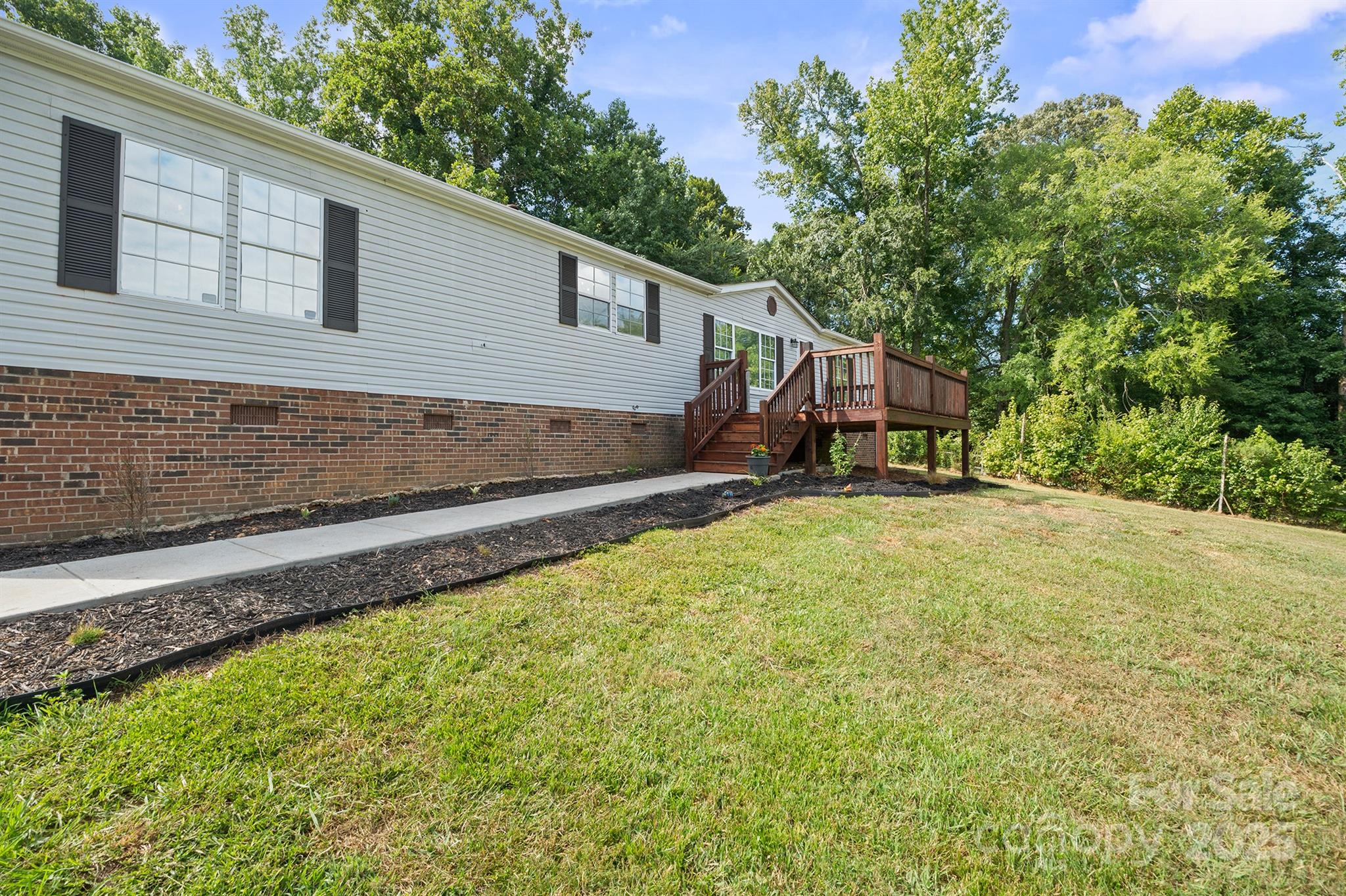 10483 Troutman Road Midland, NC 28107 - Photo 20 of 21 a view of a house with a backyard and trees