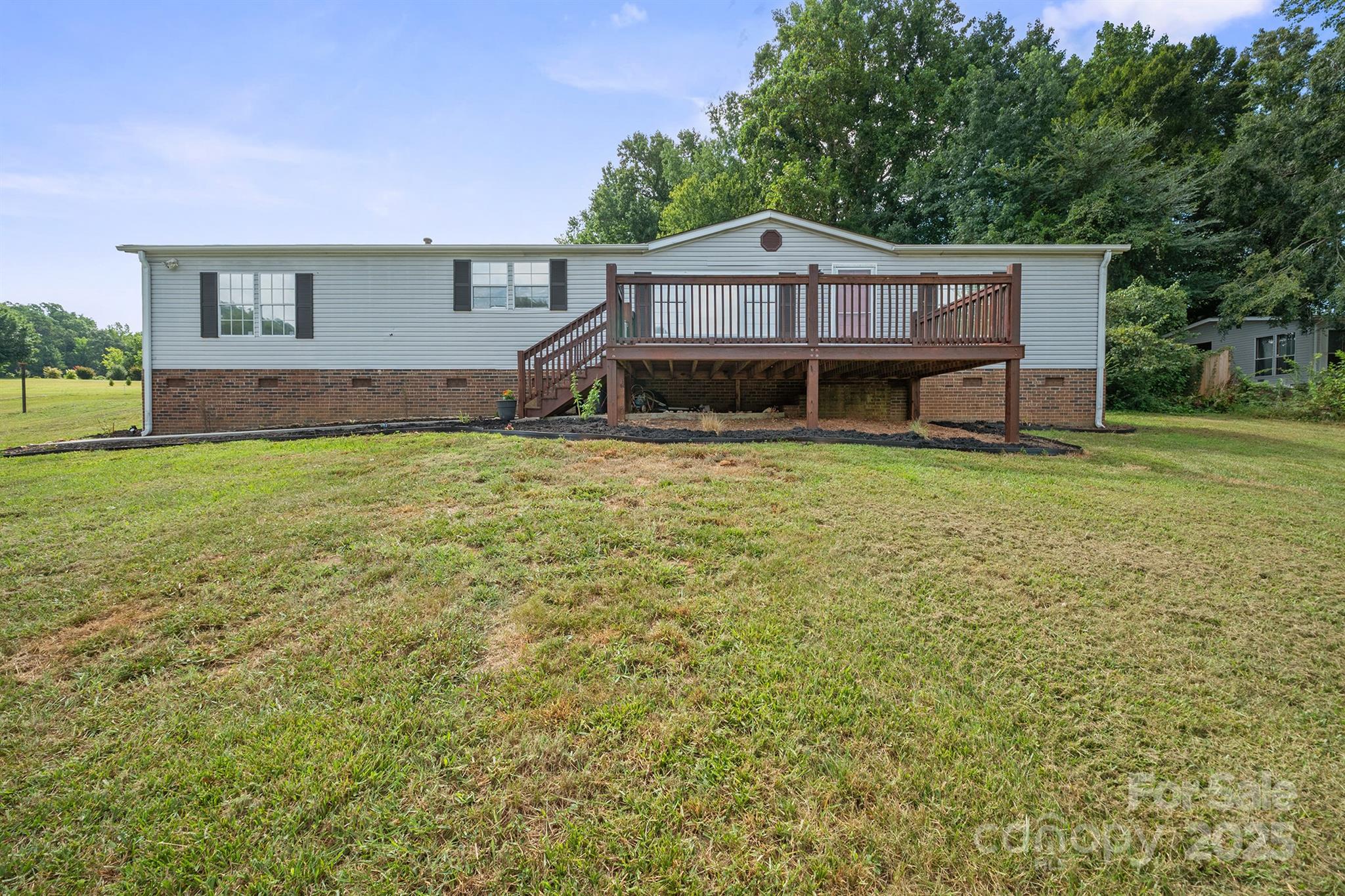 10483 Troutman Road Midland, NC 28107 - Photo 3 of 21 a house with trees in front of it