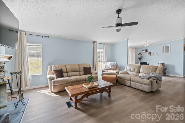 a view of a livingroom with furniture and a window