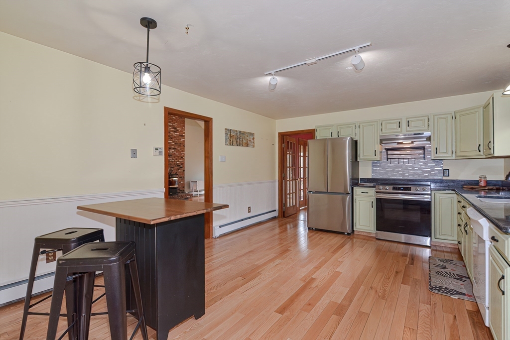 72 Allen Road Sturbridge, MA 01566 - Photo 11 of 40 a kitchen with stainless steel appliances a stove a sink and a refrigerator