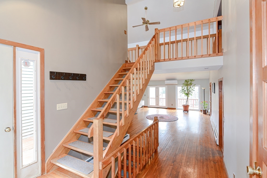 72 Allen Road Sturbridge, MA 01566 - Photo 4 of 40 a view of staircase with white walls and wooden floor