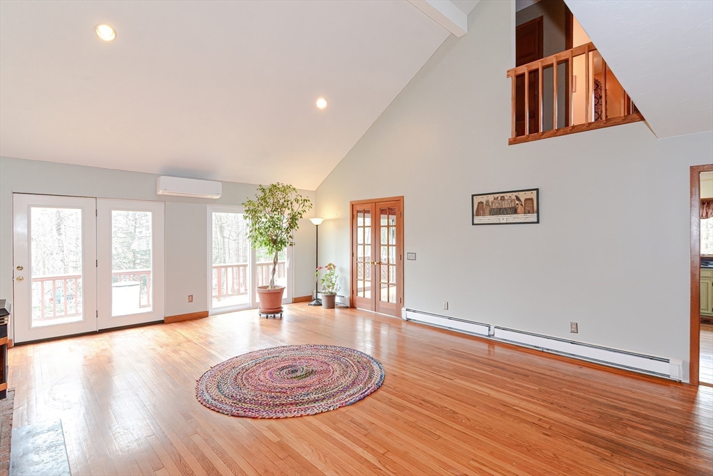 72 Allen Road Sturbridge, MA 01566 - Photo 6 of 40 an empty room with wooden floor potted plant and windows