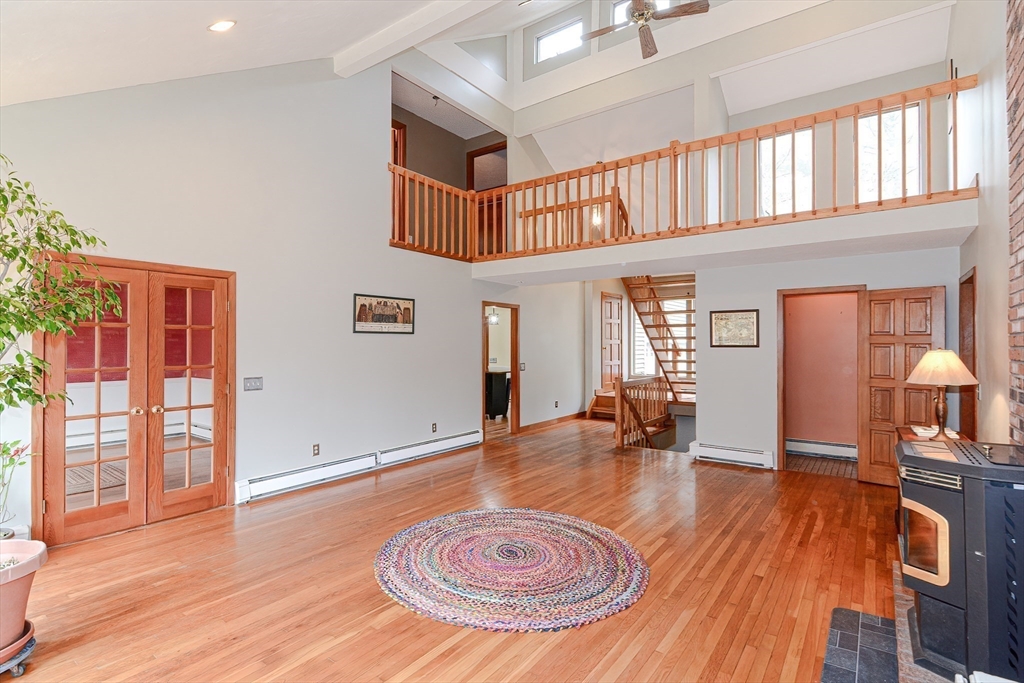 72 Allen Road Sturbridge, MA 01566 - Photo 7 of 40 a view of a livingroom with furniture hardwood floor and a ceiling fan