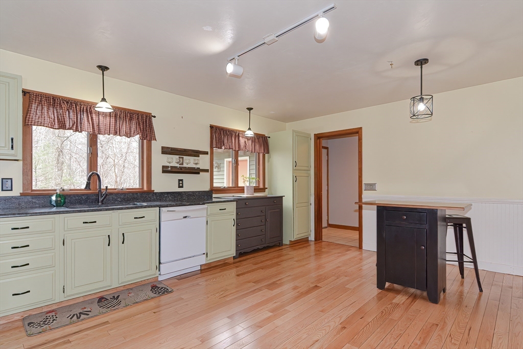 72 Allen Road Sturbridge, MA 01566 - Photo 10 of 40 a large kitchen with granite countertop a stove and a wooden floors