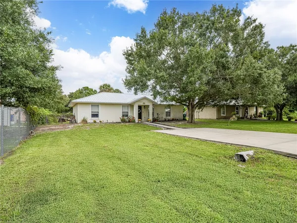 a front view of a house with yard and green space