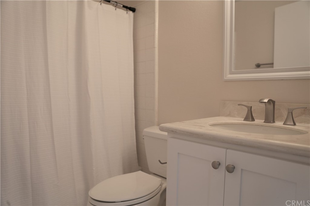 8462 Basin Circle Huntington Beach, CA 92646 - Photo 23 of 29 a bathroom with a sink toilet and a mirror